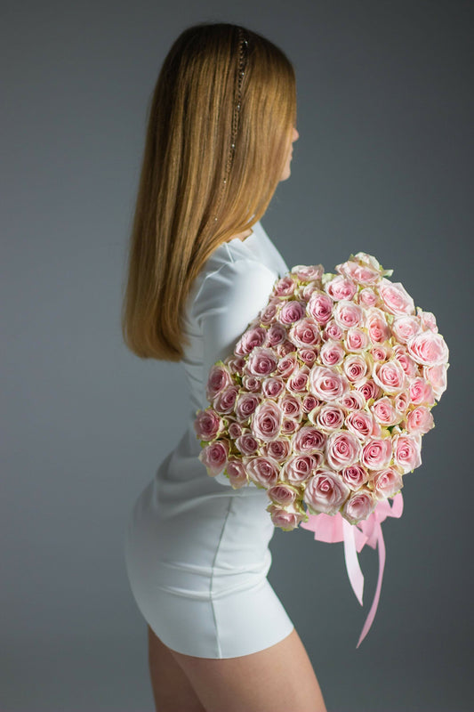 Girl with a bouquet of flowers in a dress
